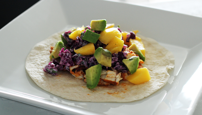 CHILI-LIME FISH TACOS WITH SOUR CREAM CABBAGE SLAW, MANGO & AVOCADO